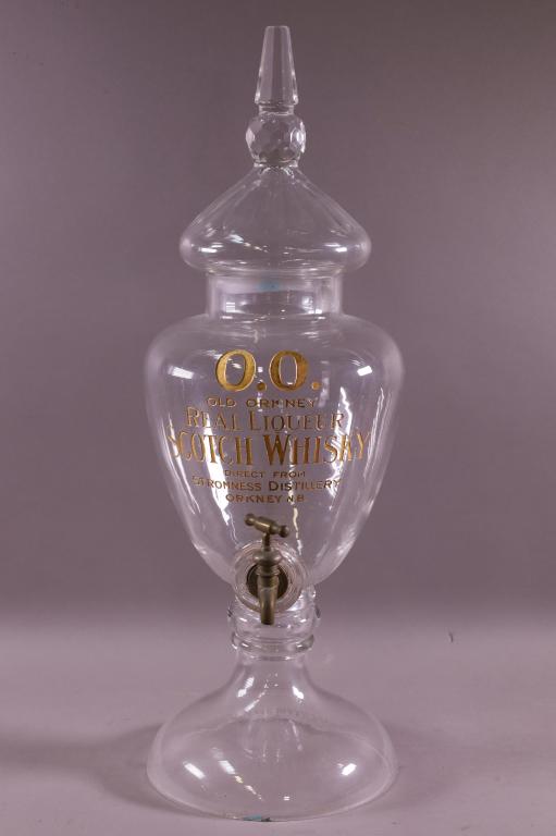 OLD ORKNEY LIQUEUR DISPENSER: OLD ORKNEY WHISKY AND LIQUOR DISPENSER. GLASS DISPENSER WITH ETCHED AND GOLD PAINT. CHIP TO BASE. 25" H. THIS ITEM EXCEEDS SIZE LIMITATIONS FOR IN HOUSE SHIPPING.