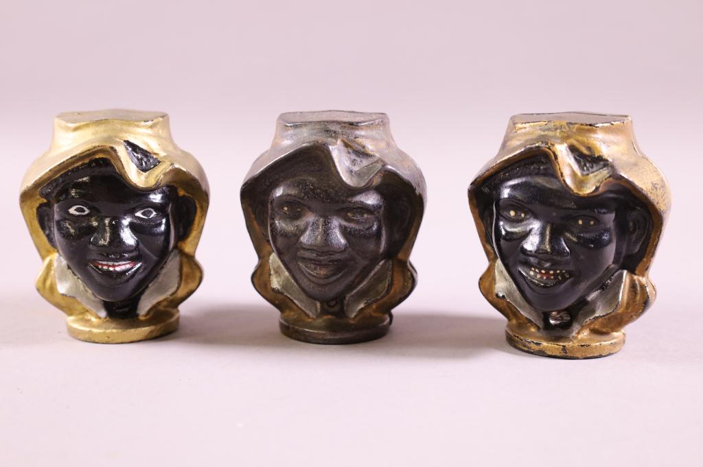 THREE CAST IRON BANKS: BLACK AMERICANA TWO FACE BANKS. PAINT WEAR. 3" H.