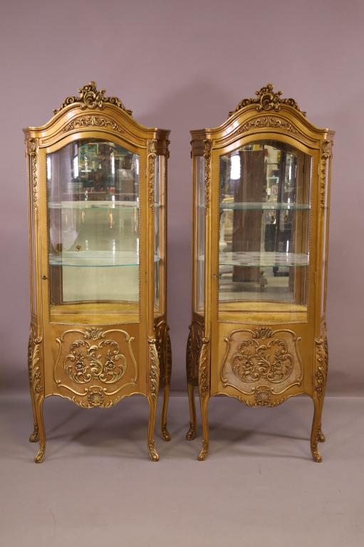 PAIR OF FRENCH STYLE GOLD GILT CURIO CABINETS: MIRRORED BACK, TWO INTERIOR GLASS SHELVES. SINGLE DOOR. ONE BROKEN PANEL. WITH KEYS. 28" W x 15" D x 70" H. THIS ITEM EXCEEDS SIZE LIMITATIONS FOR IN HOUSE SHIPPING.