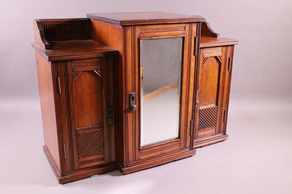 ANTIQUE HANGING HUMIDOR: BEVELED MIRROR CENTER, TWO SIDE DOORS. FITTED INTERIOR DRAWERS. 21"W x 9" D x 15" H. THIS ITEM EXCEEDS SIZE LIMITATIONS FOR IN HOUSE SHIPPING.