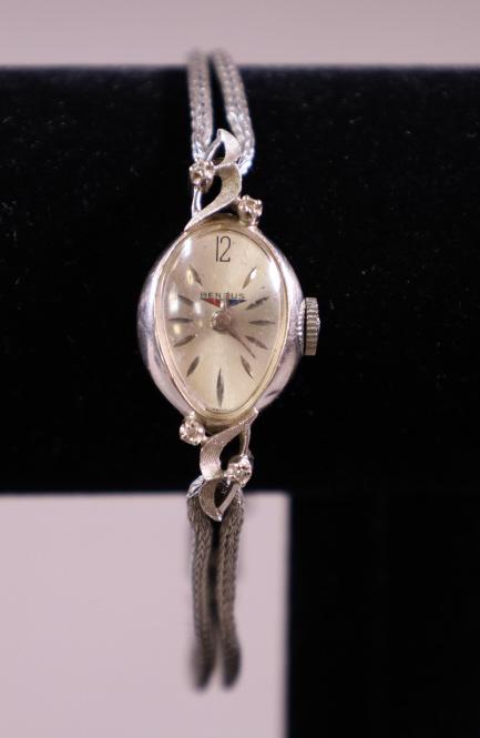 VINTAGE 14K BENRUS WRISTWATCH: 1940'S LADY'S 14K WHITE GOLD WRIST WATCH. WITH DIAMOND ON LUGS. AND STAINLESS BAND. 6 GRAMS TOTAL WEIGHT. ALL WATCHES ARE SOLD AS IS & ARE UNTESTED. WE DO NOT GUARANTEE WORKING ORDER.