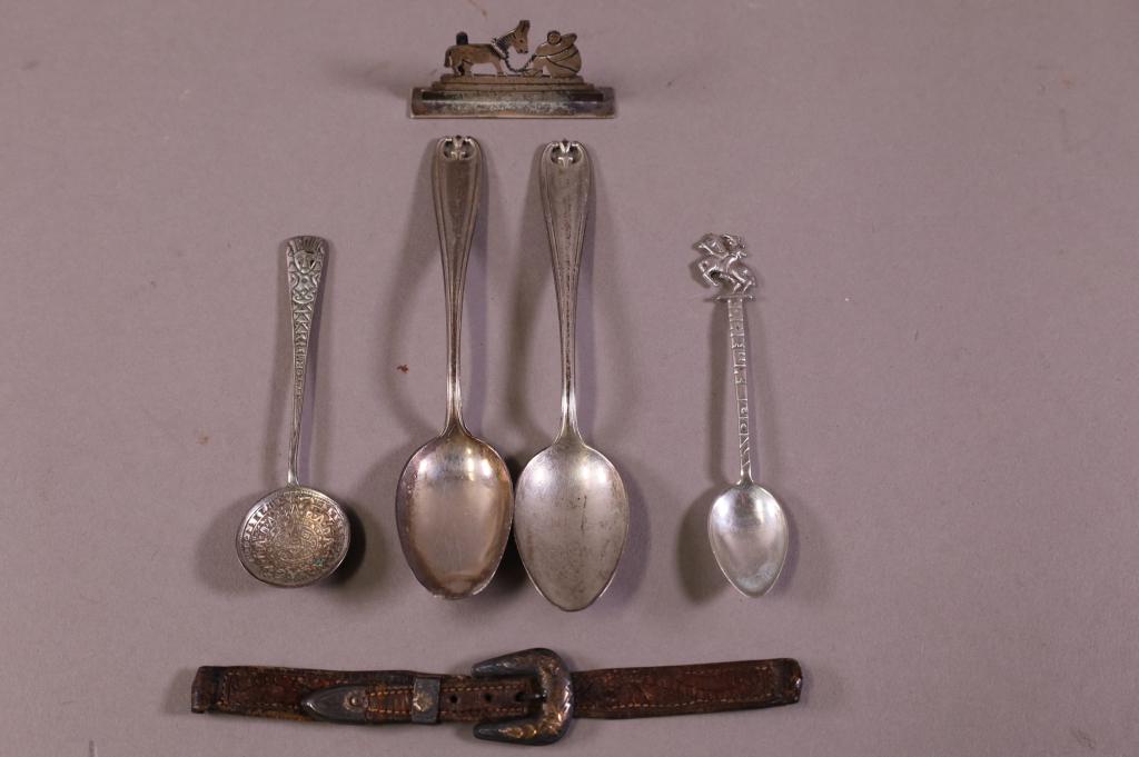 SIX PIECES OF STERLING: FOUR SPOONS, SMALL BUCKLE, & MEXICAN PLACE CARD HOLDER.