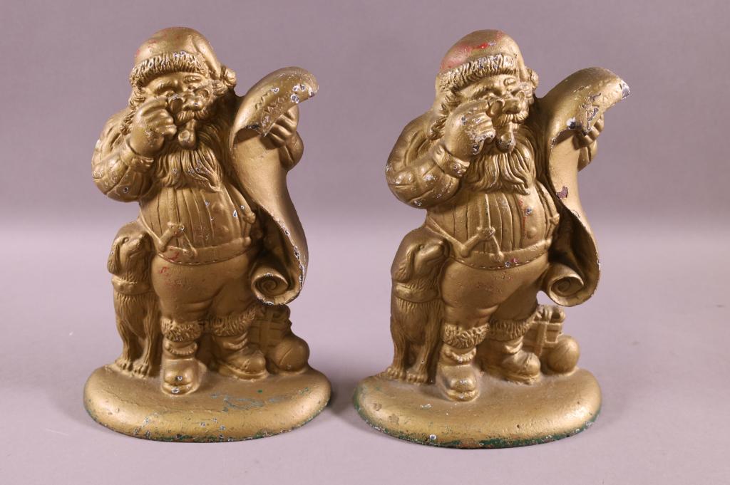 PAIR OF CAST IRON SANTA DOOR STOPS: CAST IRON SANTA DOOR STOPS. HAVE BEEN REPAINTED. 9" H.
