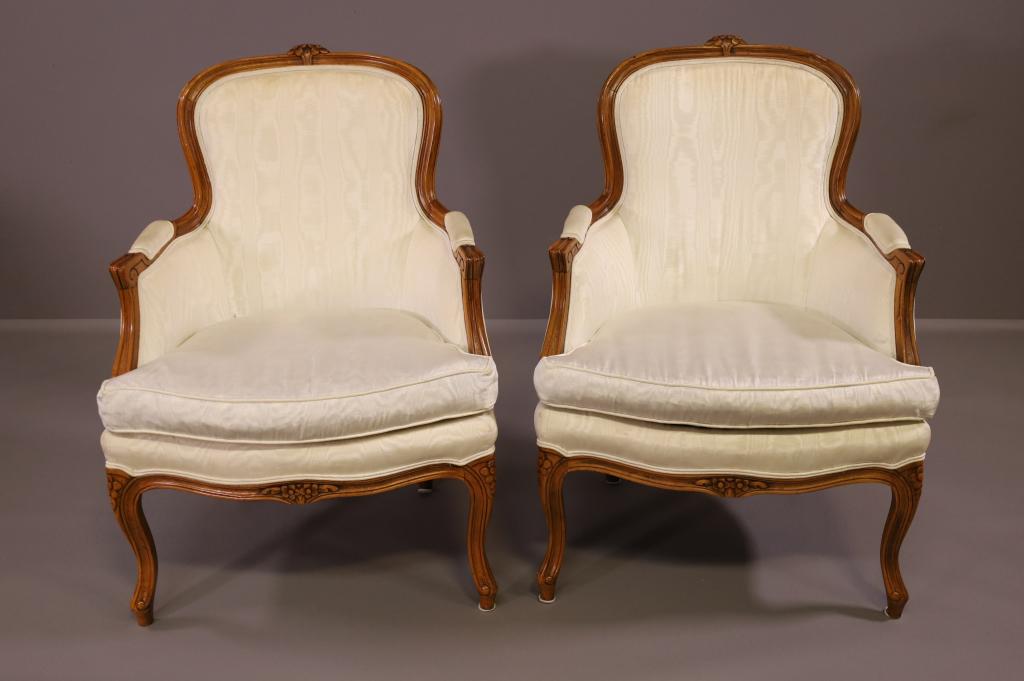 PAIR OF COUNTRY FRENCH ARMCHAIRS: CARVED FRAME. UPHOLSTERED DOWN FILLED CUSHIONS. DISCOLORATION TO FABRIC. 27" W x 26" D x 37" H. THIS ITEM EXCEEDS SIZE LIMITATIONS FOR IN HOUSE SHIPPING.