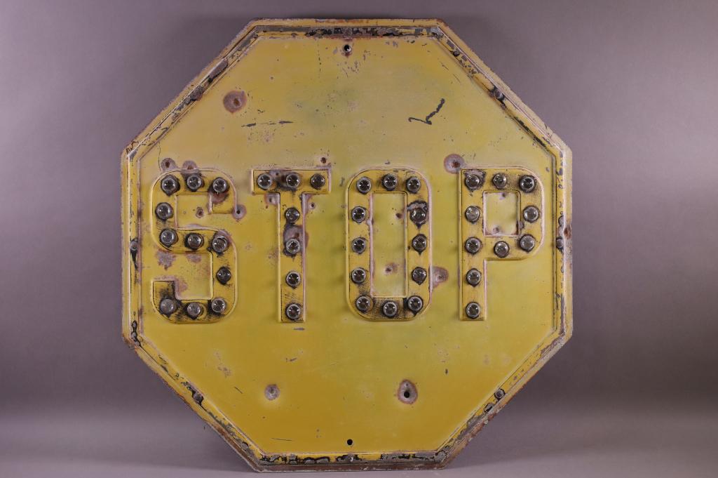 PRESSED STEEL YELLOW STOP SIGN W/ GLASS CAT EYES (1 of 2)