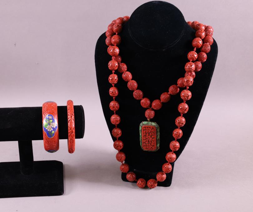 FOUR PIECES OF CINNABAR JEWELRY: TWO BRACELETS & TWO NECKLACES. 15" L & 11" L.