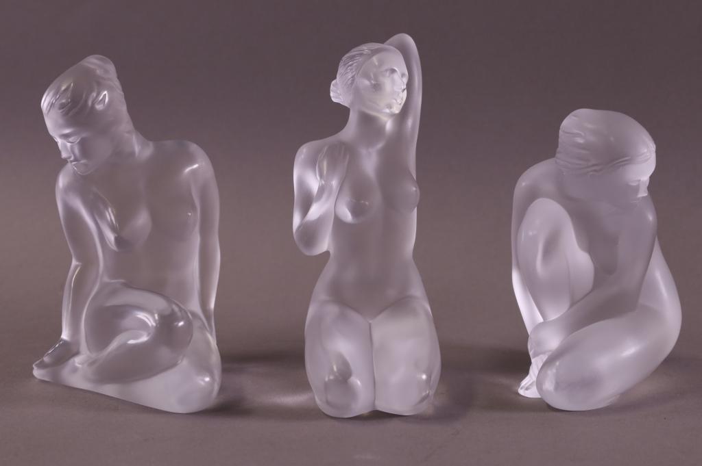 THREE LALIQUE NUDE FIGURES (1 HAS BOX): LALIQUE NUDES. FLORE NUDE FIGURE, APHRODITE NUDE FIGURE, & VENUS NUDE FIGURE. SIGNED. WITH ORIGINAL BOX. GOOD CONDITION. NO CHIPS CRACKS OR BREAKS. 4" - 5" H