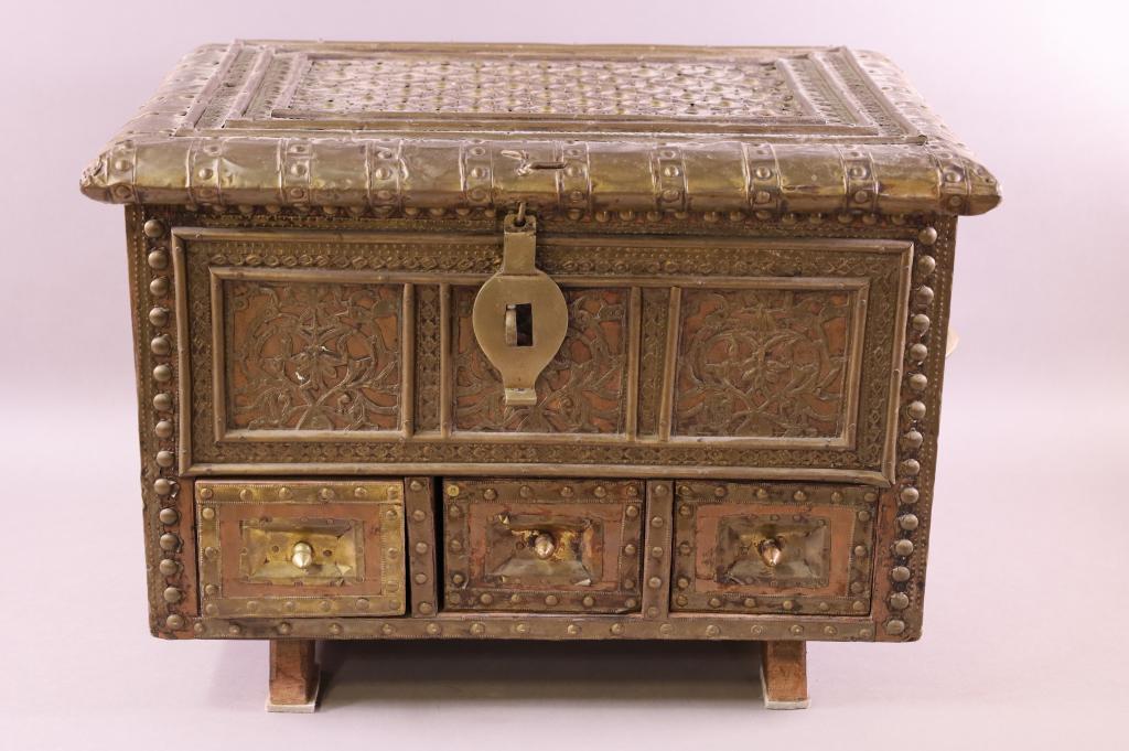 MOROCCAN STYLE TRUNK: BRASS CLAD TROUSSEAU. THREE LOWER DRAWERS, HINGED LID. 20" L x 20" D x 13 1/2" H.