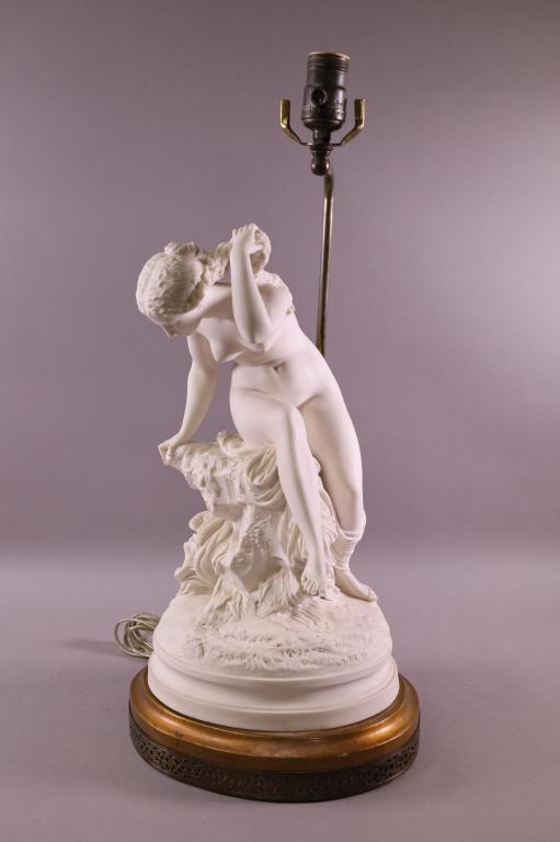 BISQUE FIGURAL TABLE LAMP: NUDE BISQUE FIGURE, ON BRASS BASE. FOOT HAS BEEN REPAIRED. 23" H.