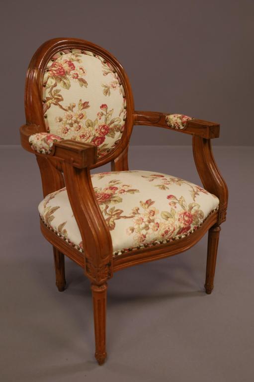 REPRODUCTION DOLL CHAIR: SMALL ARMCHAIR, BRASS TACKED. FLORAL UPHOLSTERY. 16 1/2" W x 15" D x 25" H. THIS ITEM EXCEEDS SIZE LIMITATIONS FOR IN HOUSE SHIPPING.