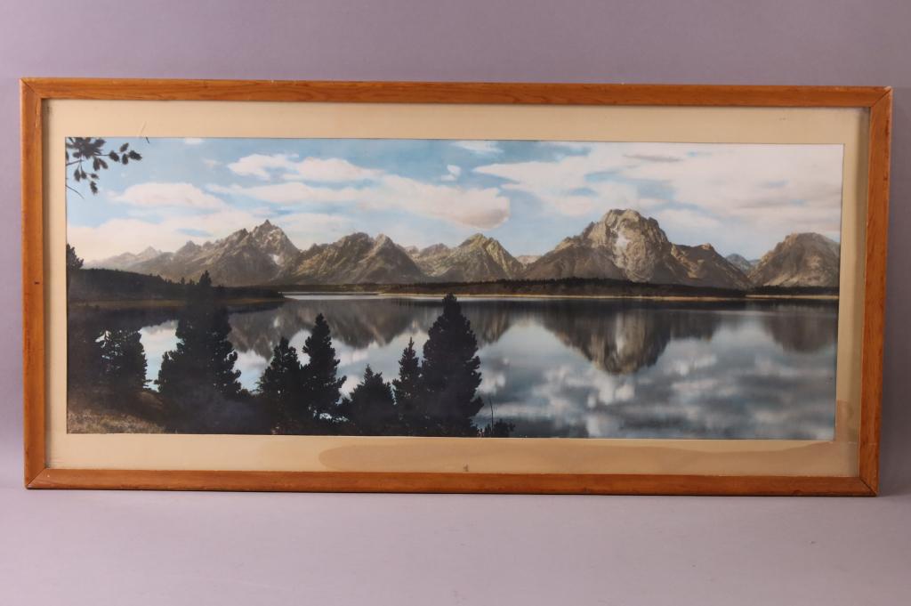 HARRISON CRANDALL HAND TINTED PHOTO JACKSON LAKE GRAND TETON: GRAND TETON HAND TINTED PHOTO BY HARRISON CRANDALL. EMBOSSED IN LOWER LEFT CRANDALL GRAND TETON NATIONAL PARK. WATER STAIN ON MAT, DOES NOT AFFECT THE ACTUAL PHOTO. 32" x 15" IN FRAME.