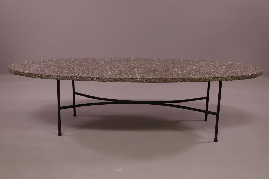 OVAL TRAVERTINE COFFEE TABLE: IRON BASE, TRAVERTINE COFEE TABLE. MINOR CHIPS ALONG EDGE. 60" L x 23" D x 16 1/2" H. THIS ITEM EXCEEDS SIZE LIMITATIONS FOR IN HOUSE SHIPPING.