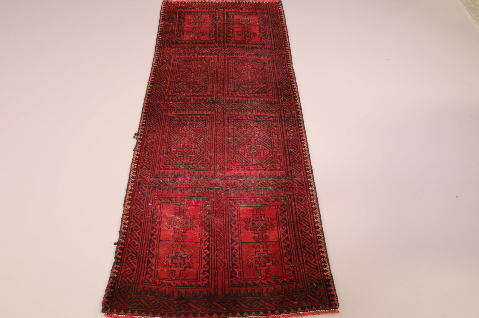 APPROX 5' 8" x 2' 2" HANDMADE WOOL RUG: MOTH DAMAGE, EDGE WEAR.