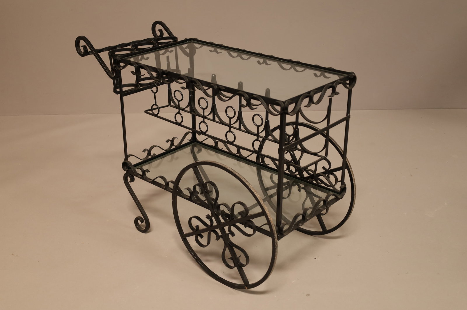 IRON GLASS TOP BAR CART: SOME WEAR & SCRATCHES TO PAINT. 39 3/4" L X 28 1/2" T X 16 1/2" W. THIS ITEM EXCEEDS SIZE LIMITATIONS FOR IN HOUSE SHIPPING.