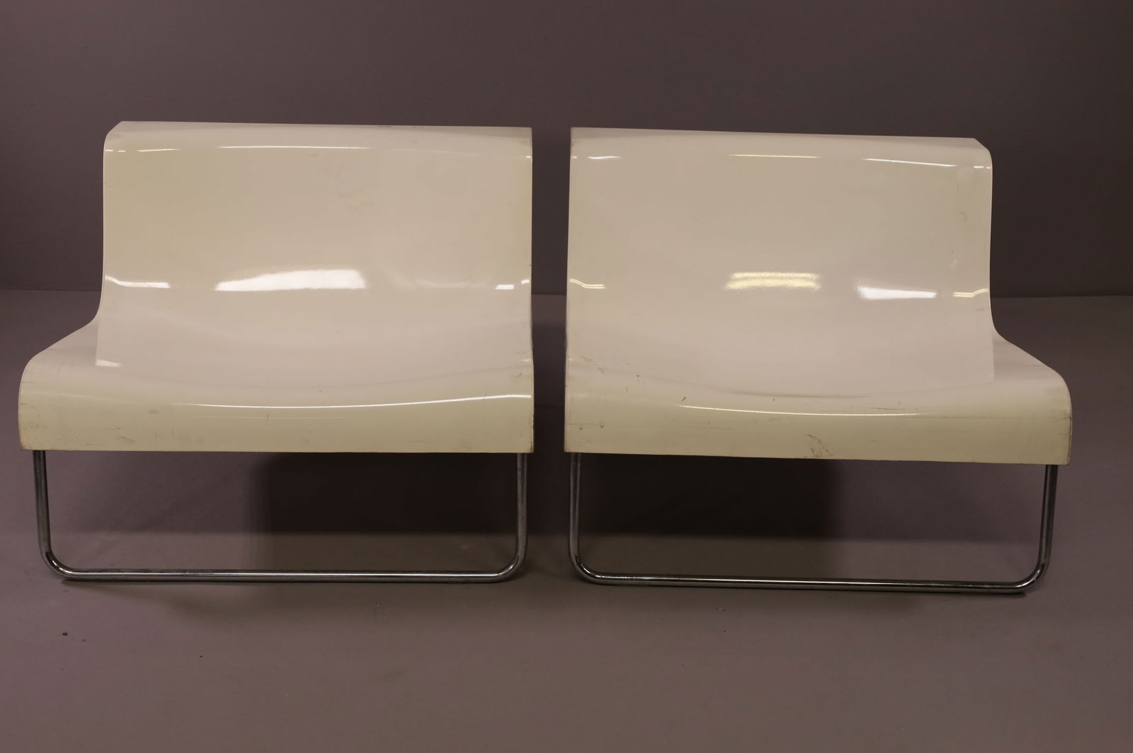 PAIR OF PIERO LISSONI LOUNGE CHAIRS: PAIR OF MOLDED LOUNGED CHAIRS, DESIGNEDBY PIERO LISSONI FOR KARTELL. MARKED ON UNDERSIDE. SURFACE SCUFFS. 33" W x 31" D x 24 1/2" H. THIS ITEM EXCEEDS SIZE LIMITATIONS FOR IN HOUSE SHIPPING.