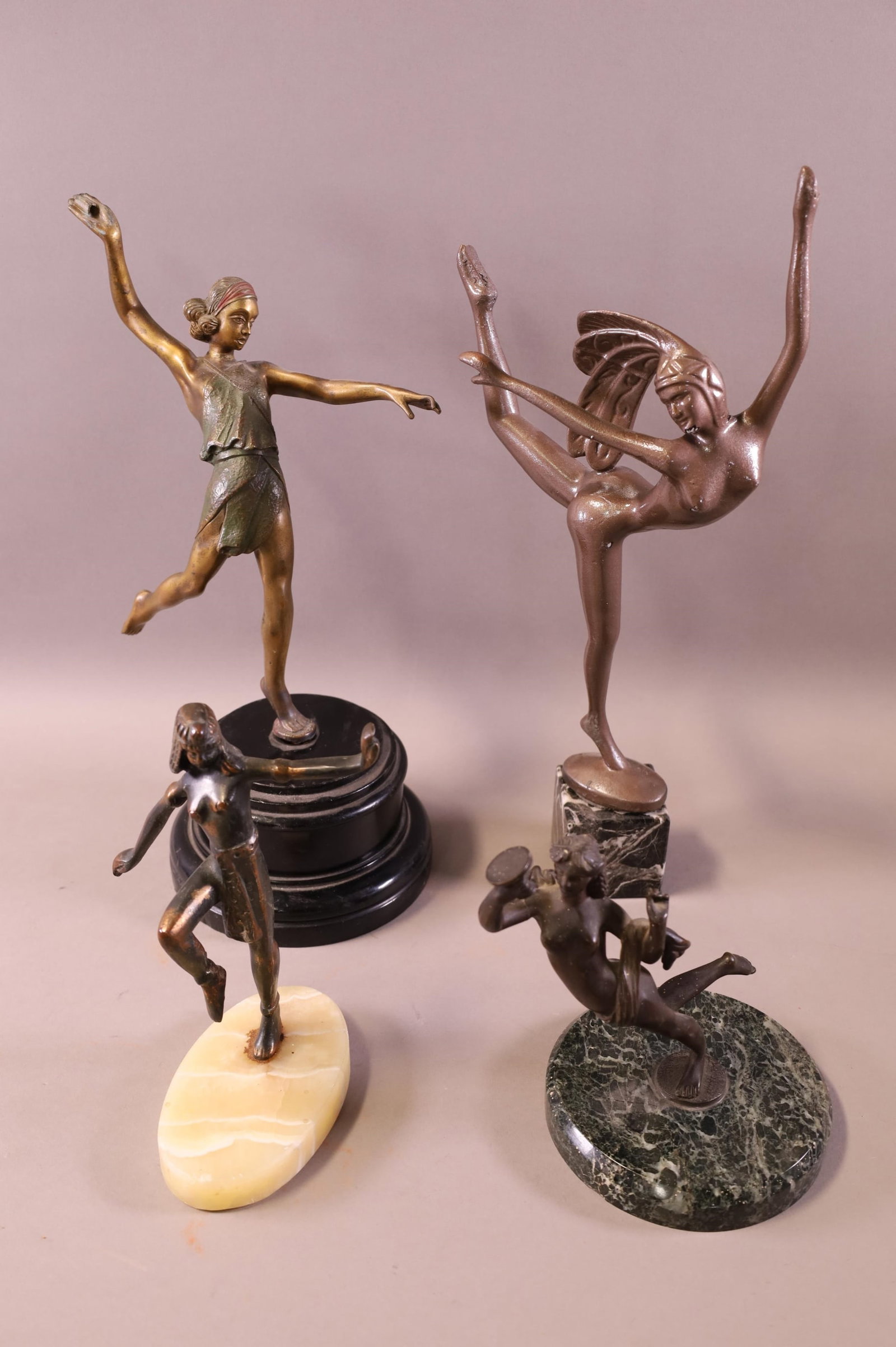4 CAST METAL LADY STATUES: FOUR FIGURES, ON STONE AND WOOD BASES. UNMARKED. ONE HAS DAMAGE TO HAND. 7" - 14" H
