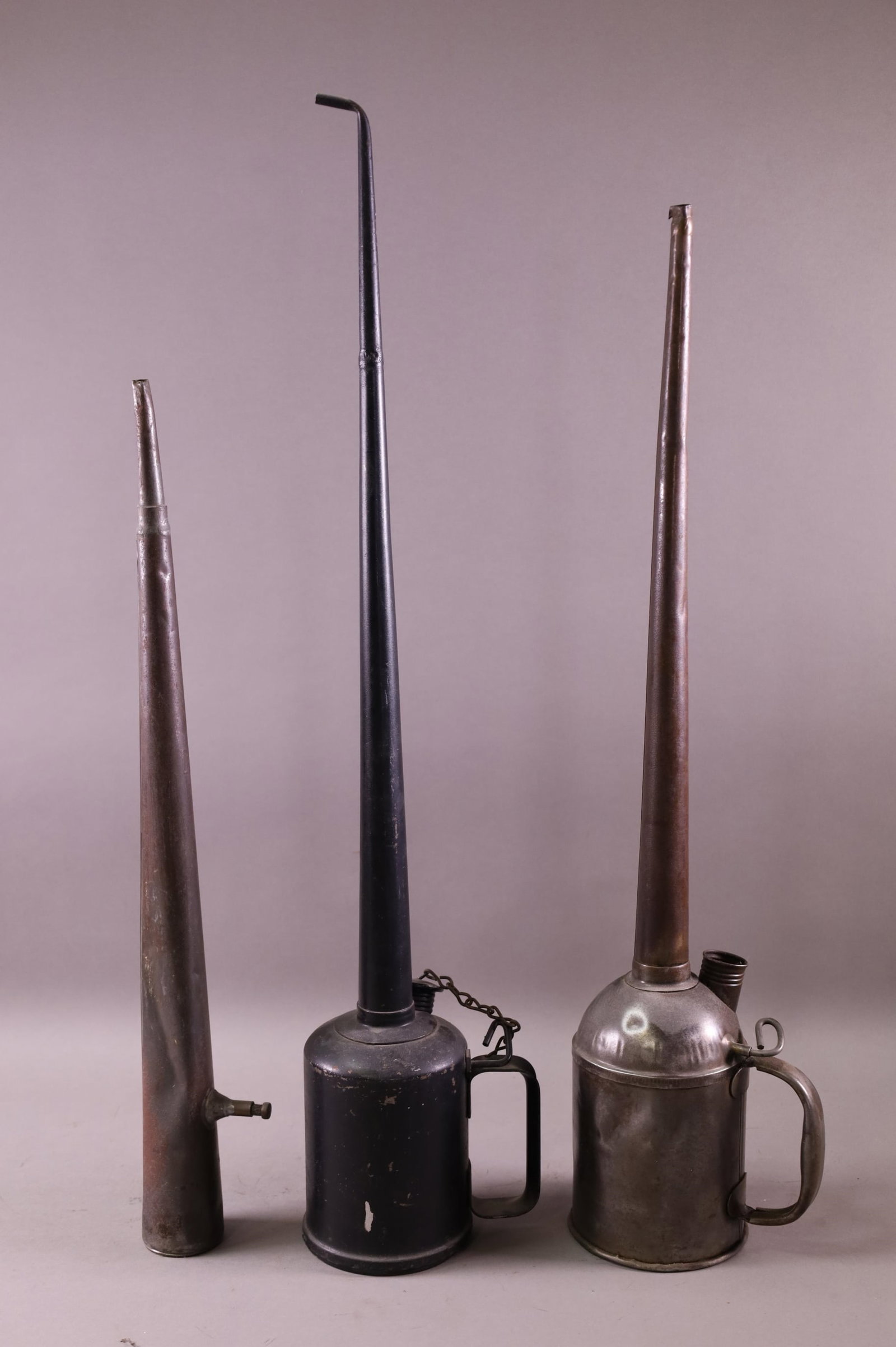 THREE POUR CANS: TALL SPOUT POUR CANS.