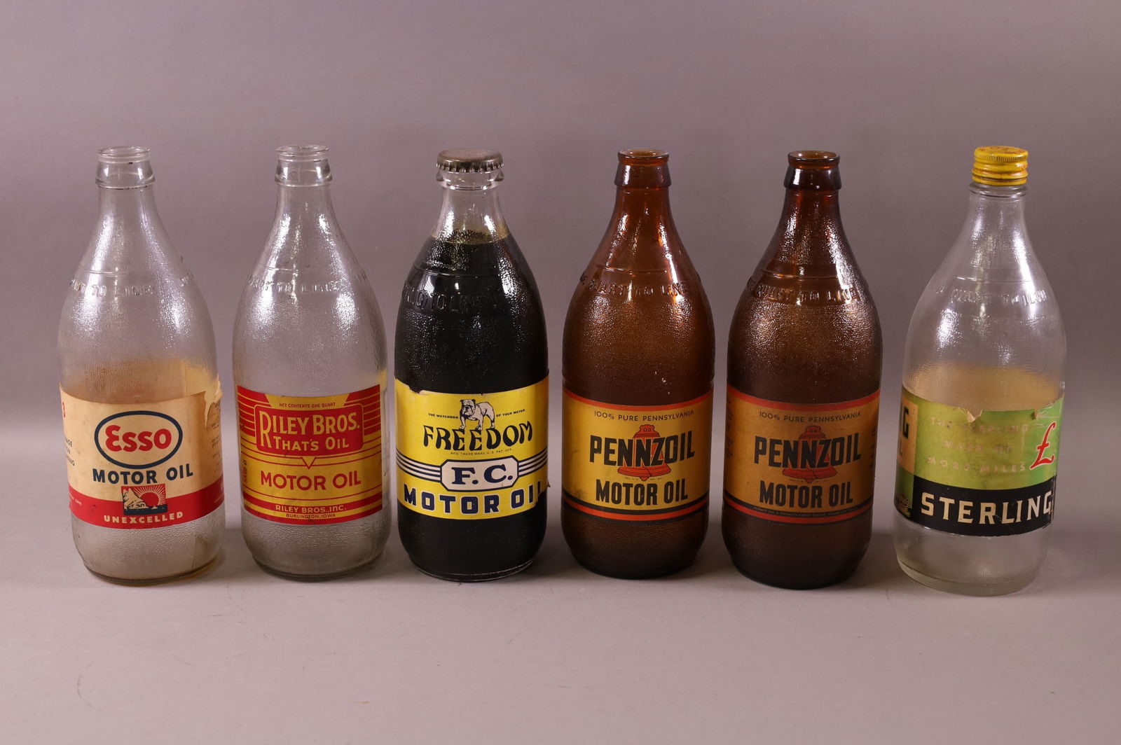 SIX OIL BOTTLES (1 of 3)