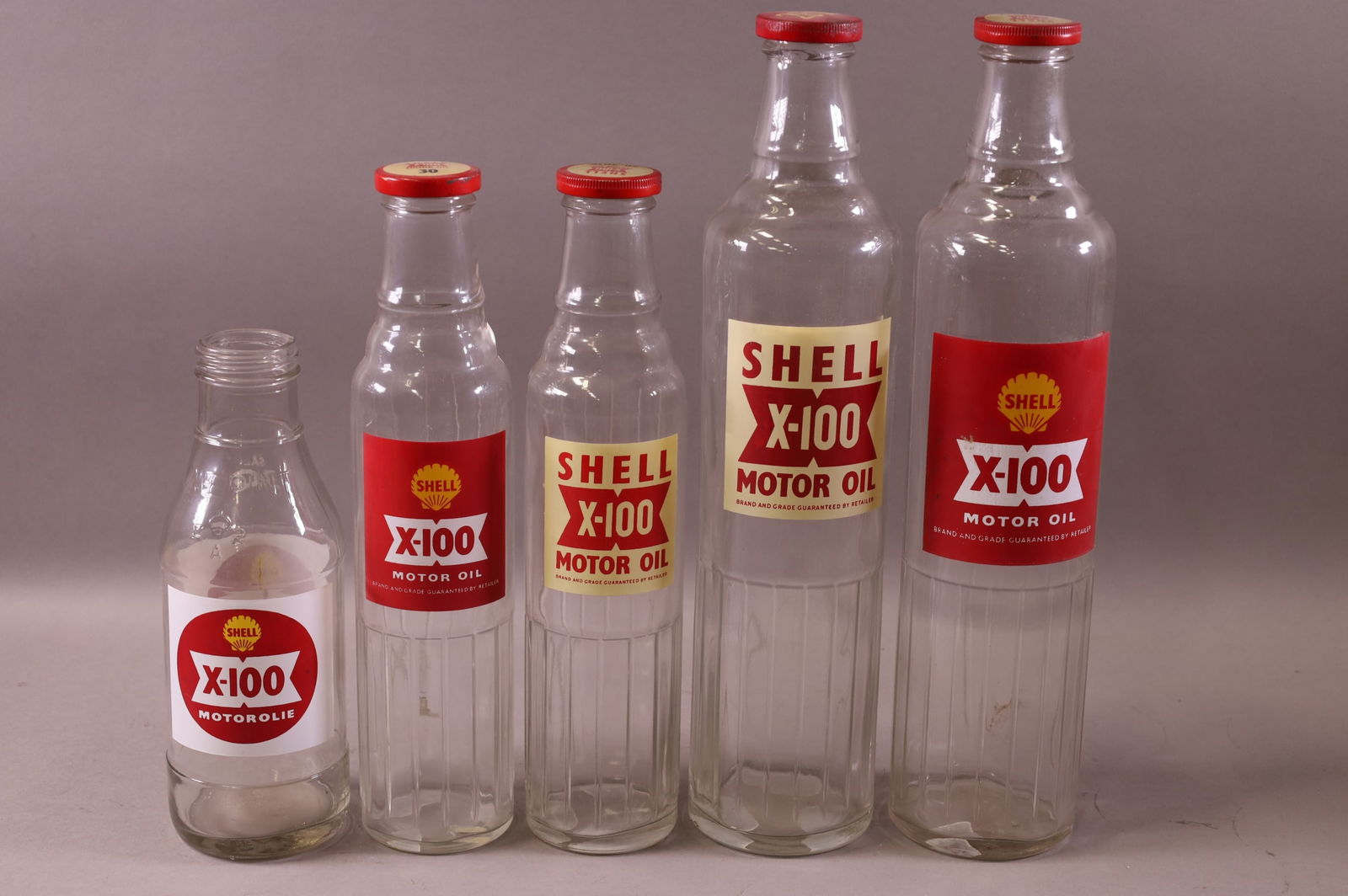 FIVE SHELL X-100 OIL BOTTLES (1 of 3)