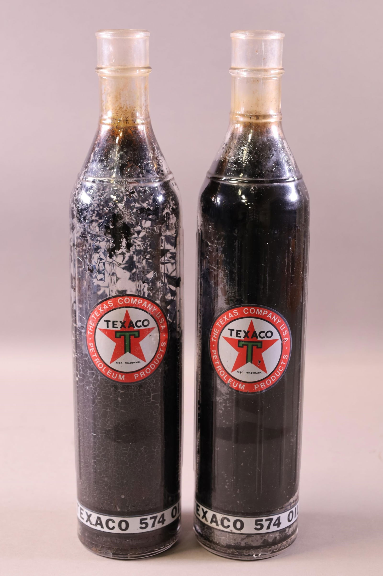 TWO TEXACO 574 OIL BOTTLES: 1 QUART TALL OIL BOTTLES, PAINTED ON INTERIOR.