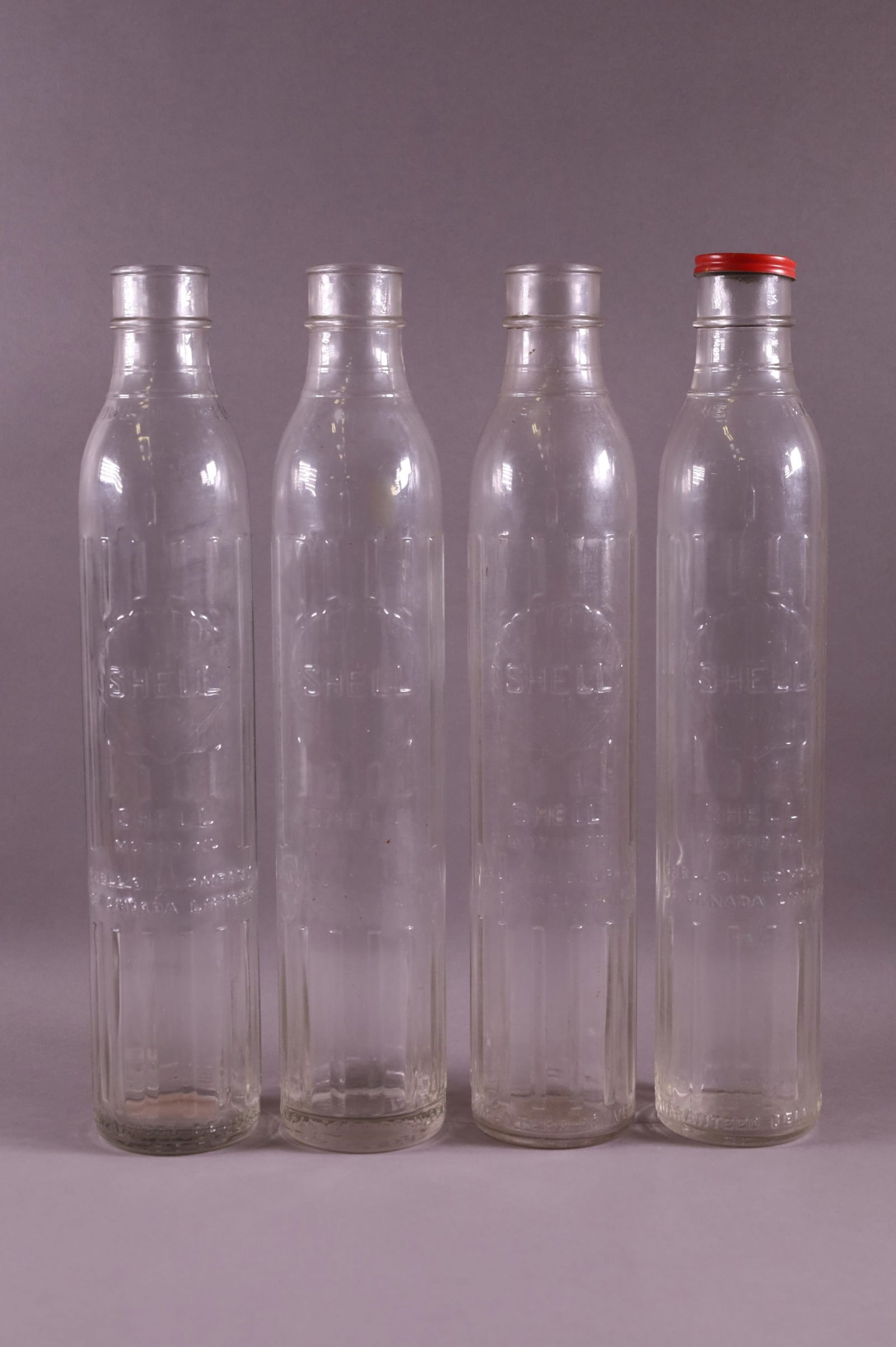 FOUR SHELL OIL BOTTLES (1 of 2)
