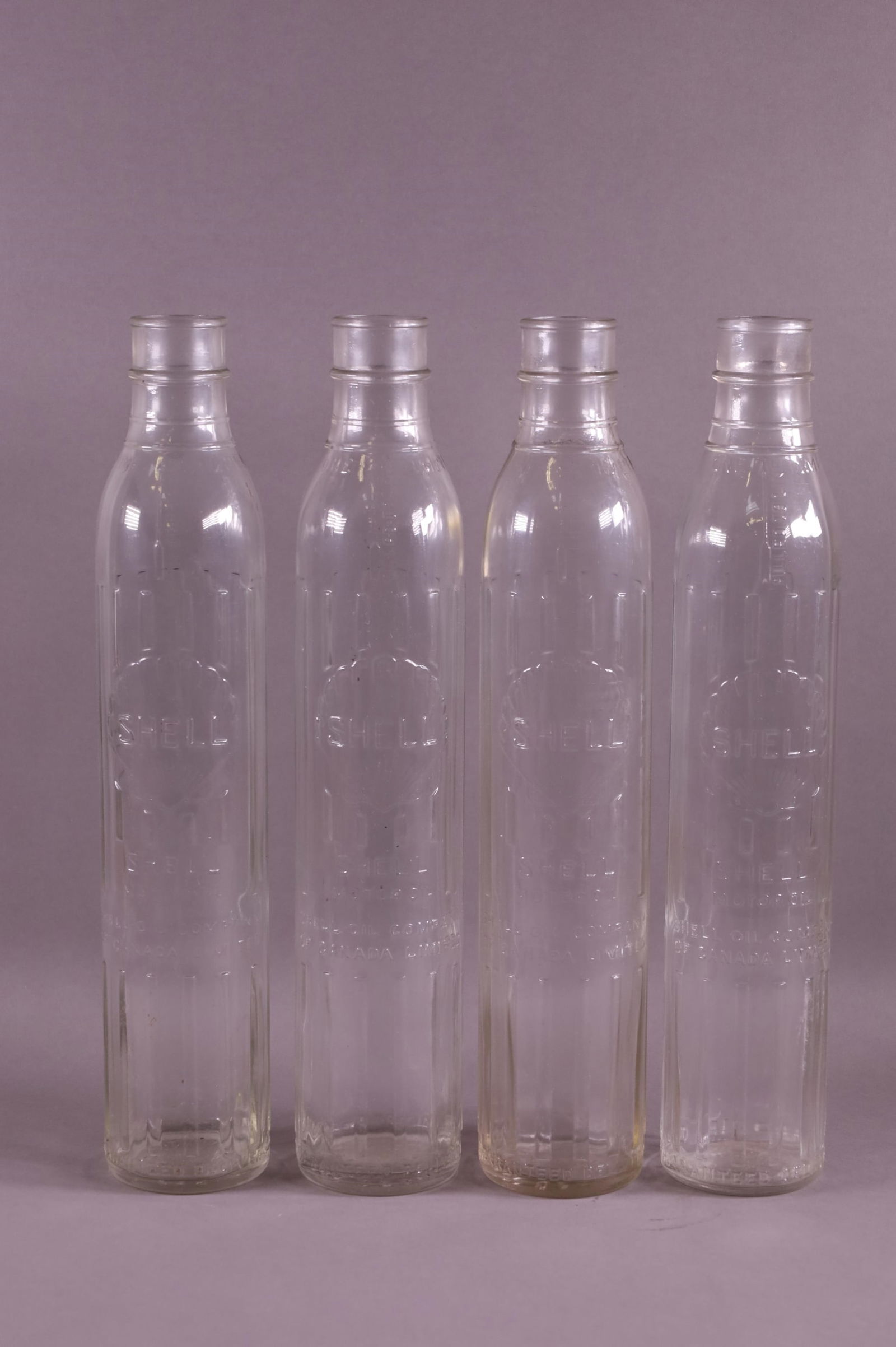 FOUR SHELL OIL BOTTLES (1 of 2)