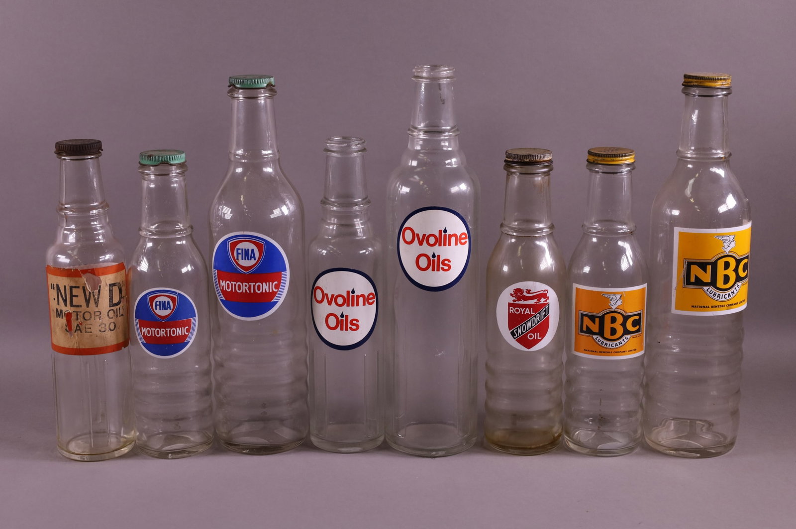 EIGHT OIL BOTTLES (1 of 3)