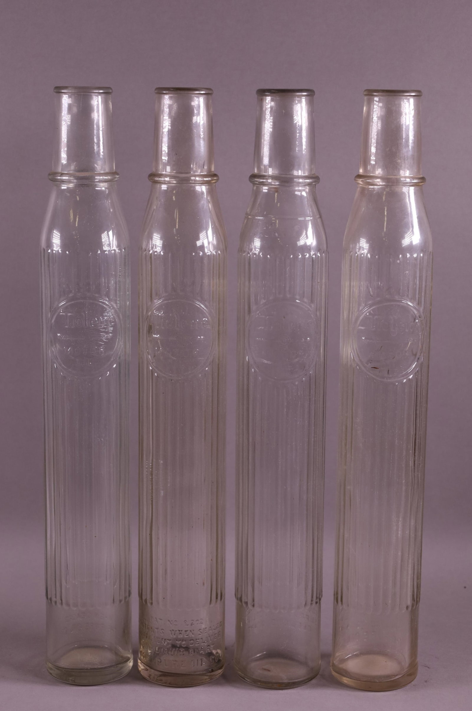 FOUR TIOLENE OIL BOTTLES (1 of 2)