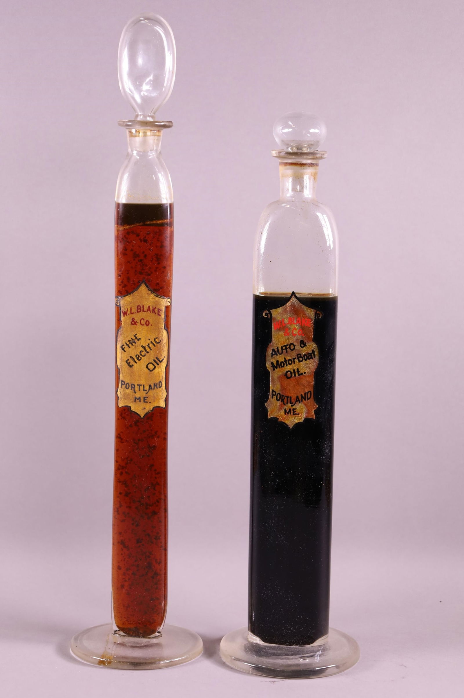 TWO TALL COUNTER TOP DISPLAY OIL BOTTLES (1 of 3)