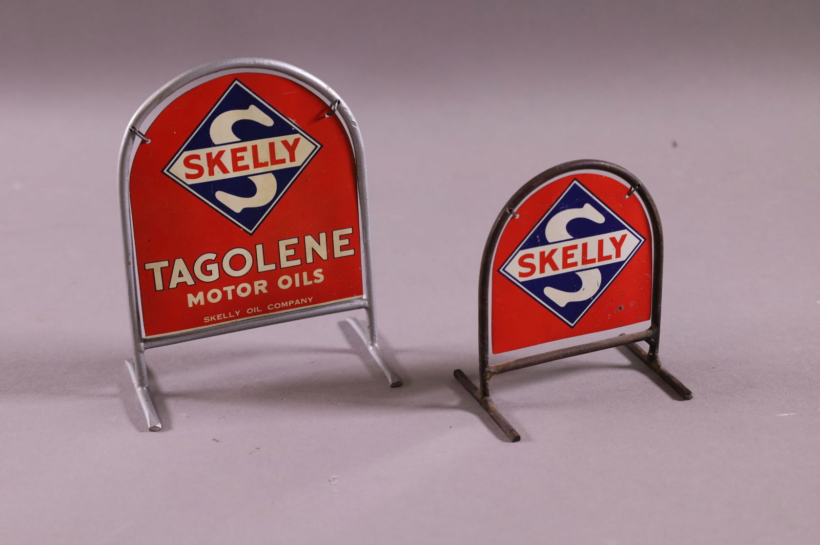 TWO SKELLY TOY CURB SIGNS (1 of 3)