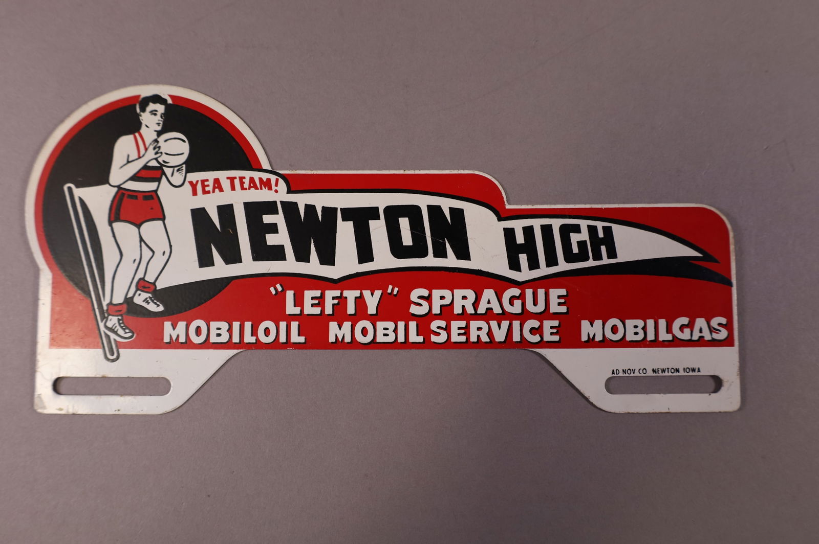 NEWTON HIGH (IOWA) TIN LICENSE PLATE TOPPER: NEWTON HIGH, "LEFTY" SPRAGUE MOBILOIL MOBIL SERVICE MOBILGAS TIN LICENSE PLATE TOPPER. NEWTON IOWA. GOOD CONDITION. 9 1/2" W x 4 1/2" H