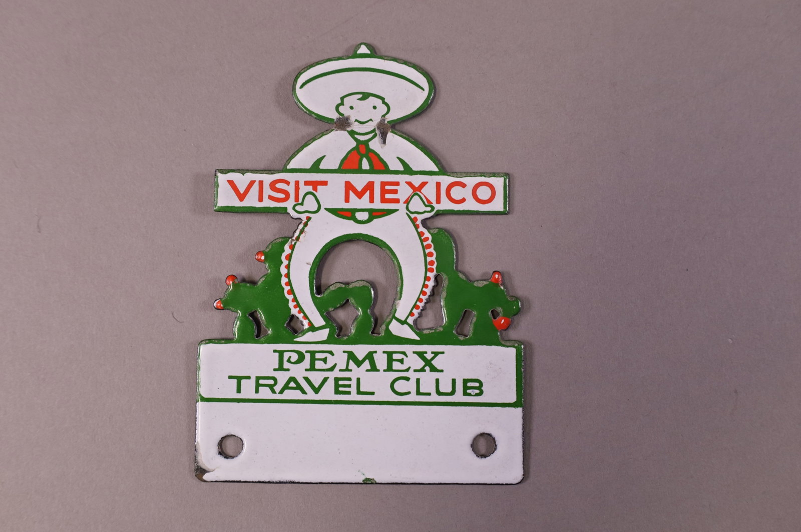 PEMEX TRAVEL CLUB PORCELAIN LICENSE PLATE TOPPER: PEMEX TRAVEL CLUB, VISIT MEXICO PORCELAIN LICENSE PLATE TOPPER. MINOR CHIPS. 3 5/8" W x 5" H.