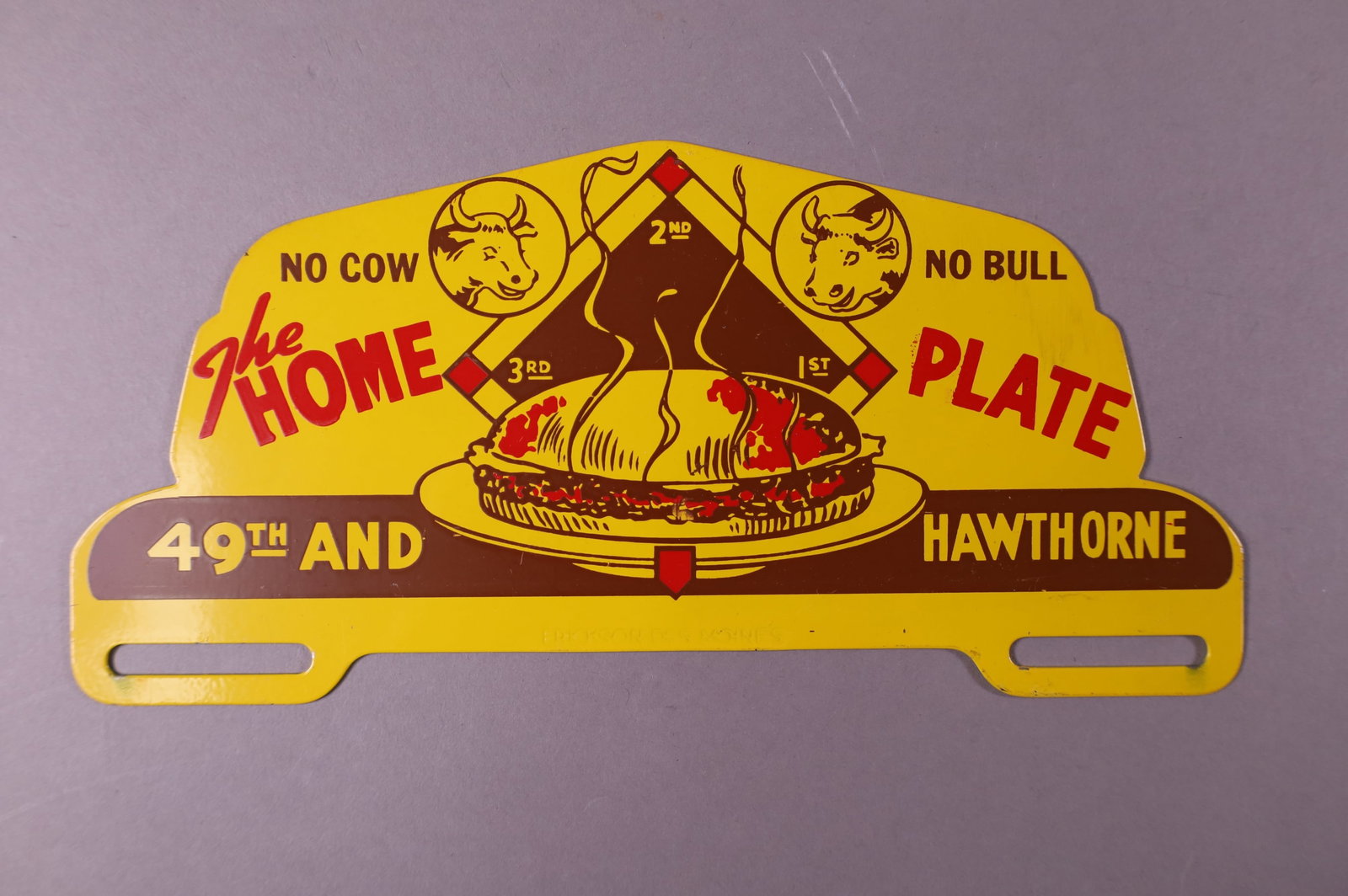THE HOME PLATE TIN LICENSE PLATE TOPPER: THE HOME PLATE, NO COW NO BULL. 49tH AND HAWTHORNE TIN LICENSE PLATE TOPPER. GOOD CONDITION. 10" W x 4 1/2' H