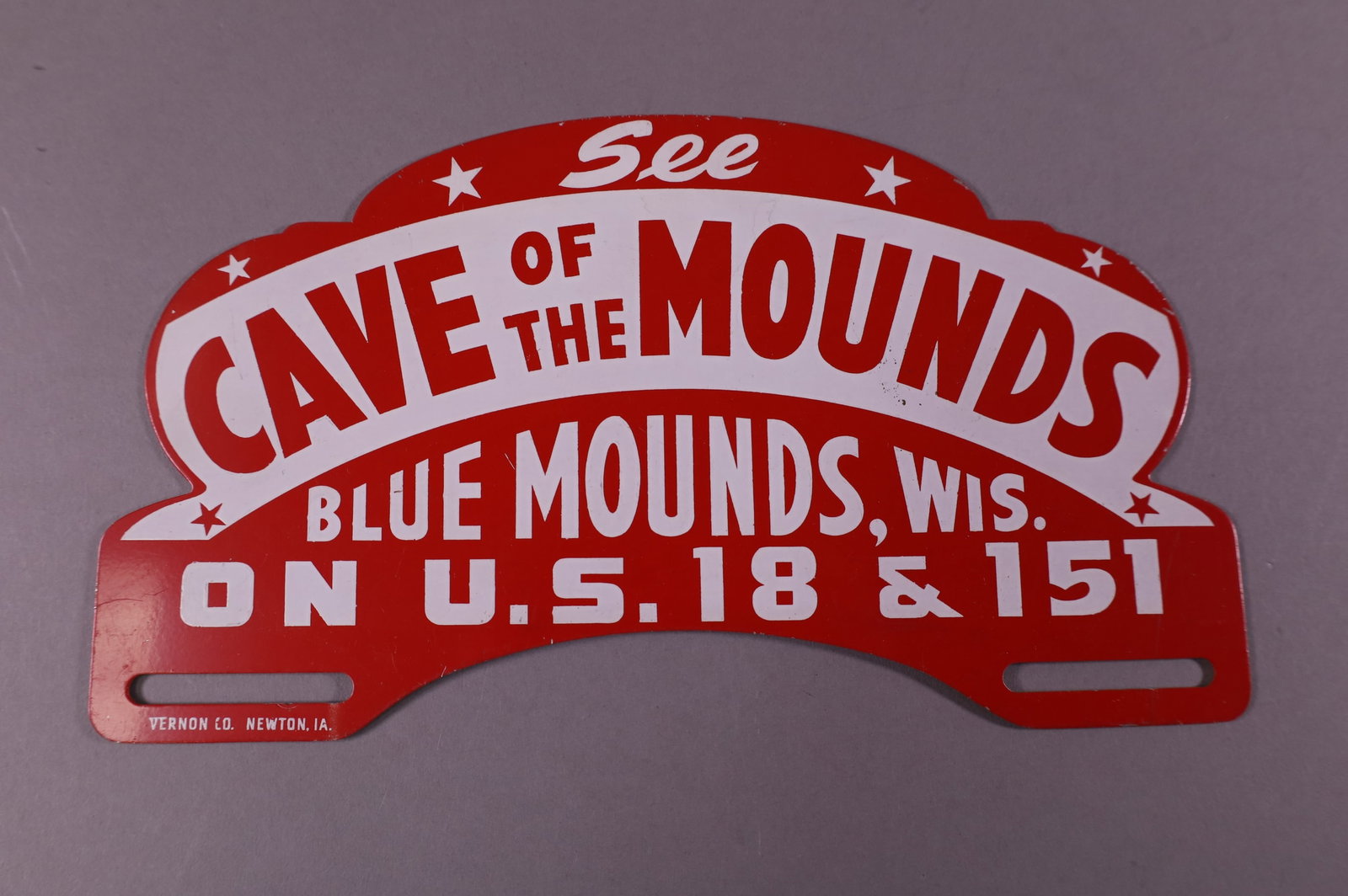CAVE OF THE MOUNDS TIN LICENSE PLATE TOPPER: SEE CAVE OF THE MOUNDS BLUE MOUNDS WISX. TIN LICENSE PLATE TOPPER. LIGHT SURFACE SCRATCHES. 10" W x 5 1/2" H
