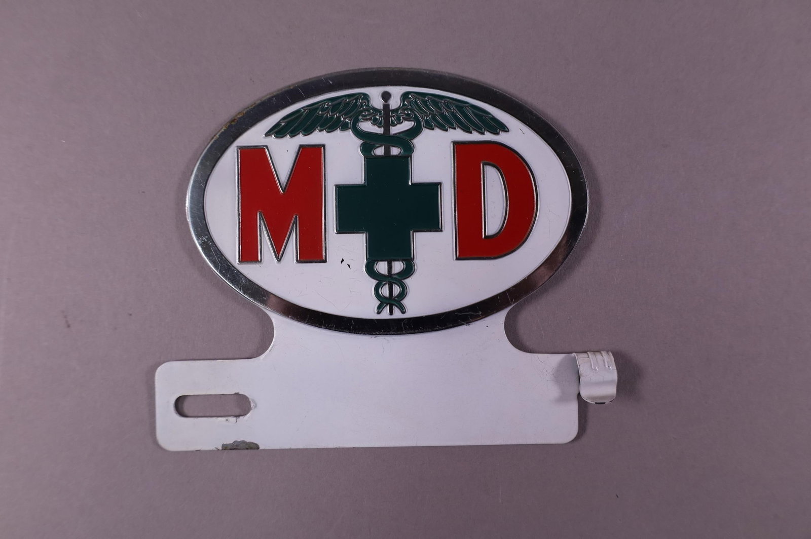 MEDICAL LICENSE PLATE TOPPER: M.D. LICENSE PLATE TOPPER. GOOD CONDITION. 4 1/2" W x 4 1/4" H