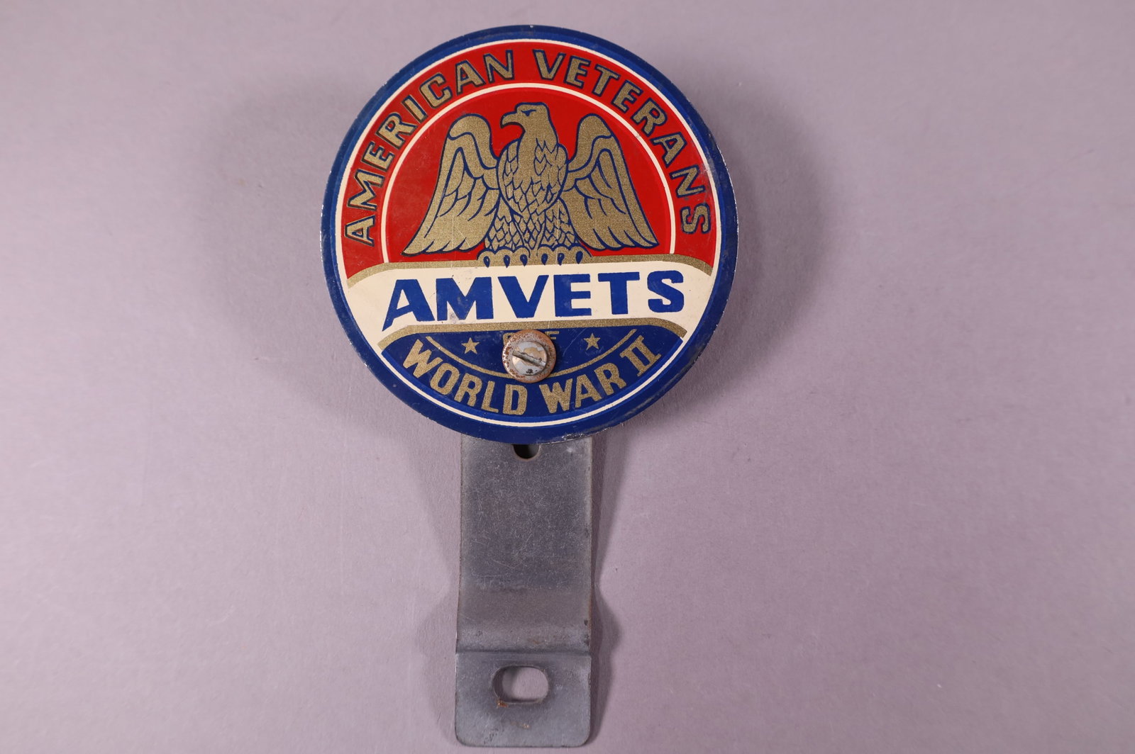 AMVETS WWII TIN LICENSE PLATE TOPPER: AMERICAN VETERANS AMVETS, WORLD WAR II TIN LICENSE PLATE TOPPER. 4" DIAM.