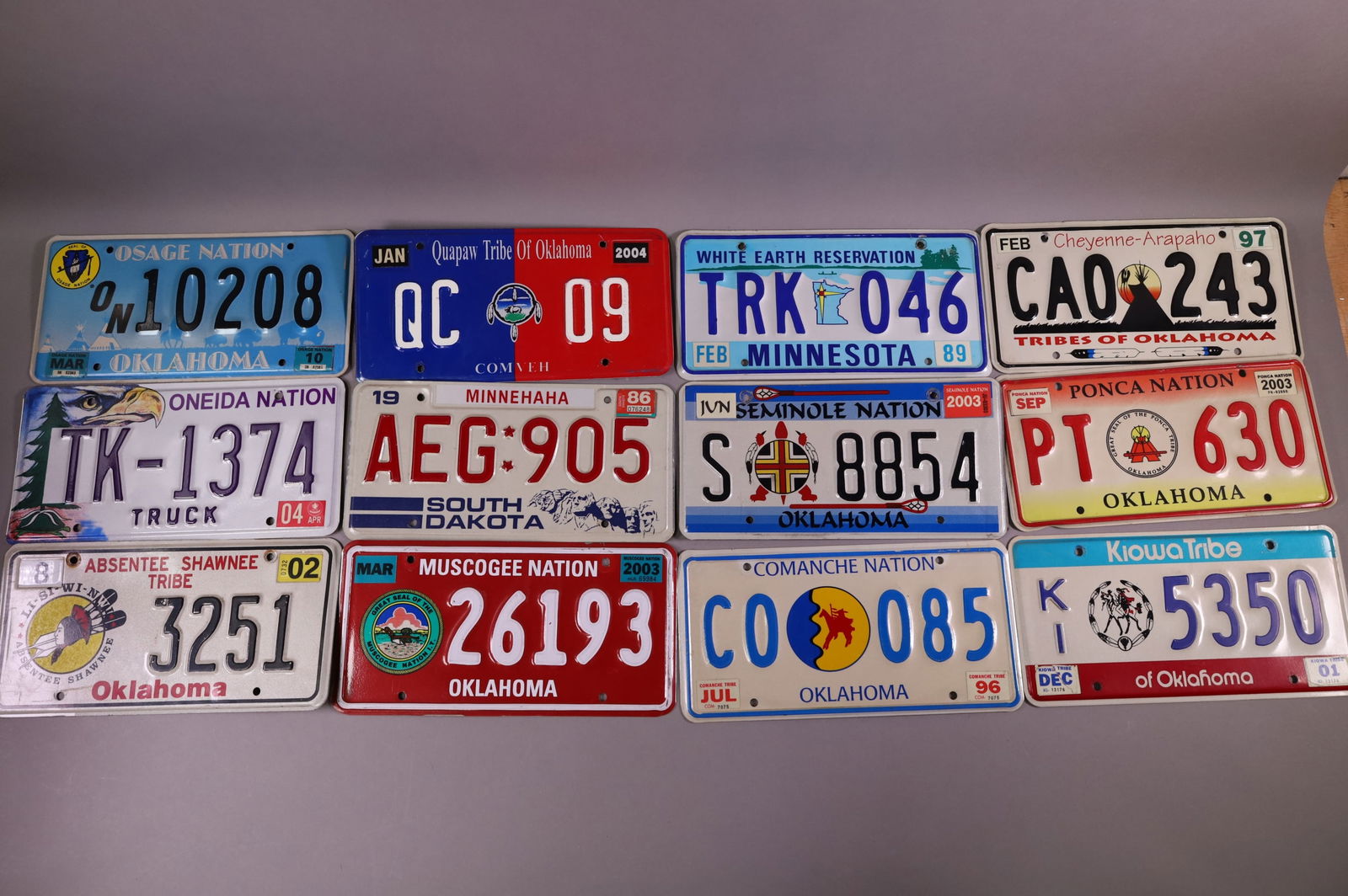 12 NATIVE AMERICAN LICENSE PLATES: INCLUDING, KIOWA TRIBE, PONCA NATION, SEMINOLE NATION, AND MORE
