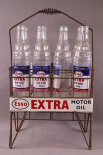 8-Esso Extra Motor Oil Bottles in Wire Rack: rated 7.5, 25"x16"x9", bottles are all in good condition, wire rack and signs have wear and scratches. This lot exceeds size limitations for in house shipping.