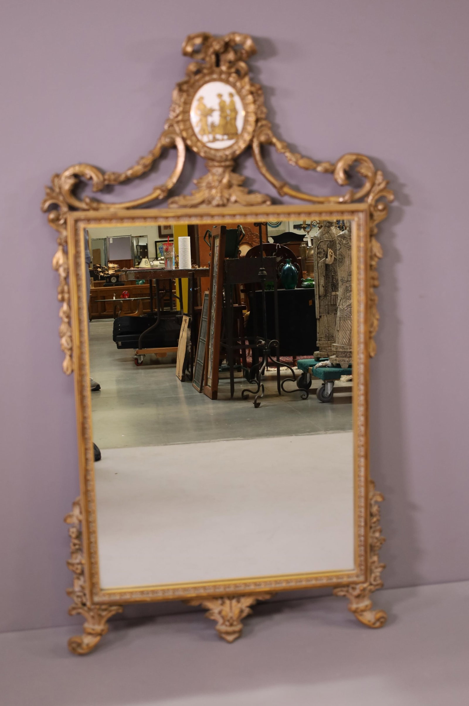 GESSO WALL MIRROR W/ PORCELAIN PLAQUE: WALL MIRROR WITH UPPER PORCELAIN MEDALLION. REPAIRS THROUGHOUT. 27" W x 49" H. THIS ITEM EXCEEDS SIZE LIMITATIONS FOR IN HOUSE SHIPPING.