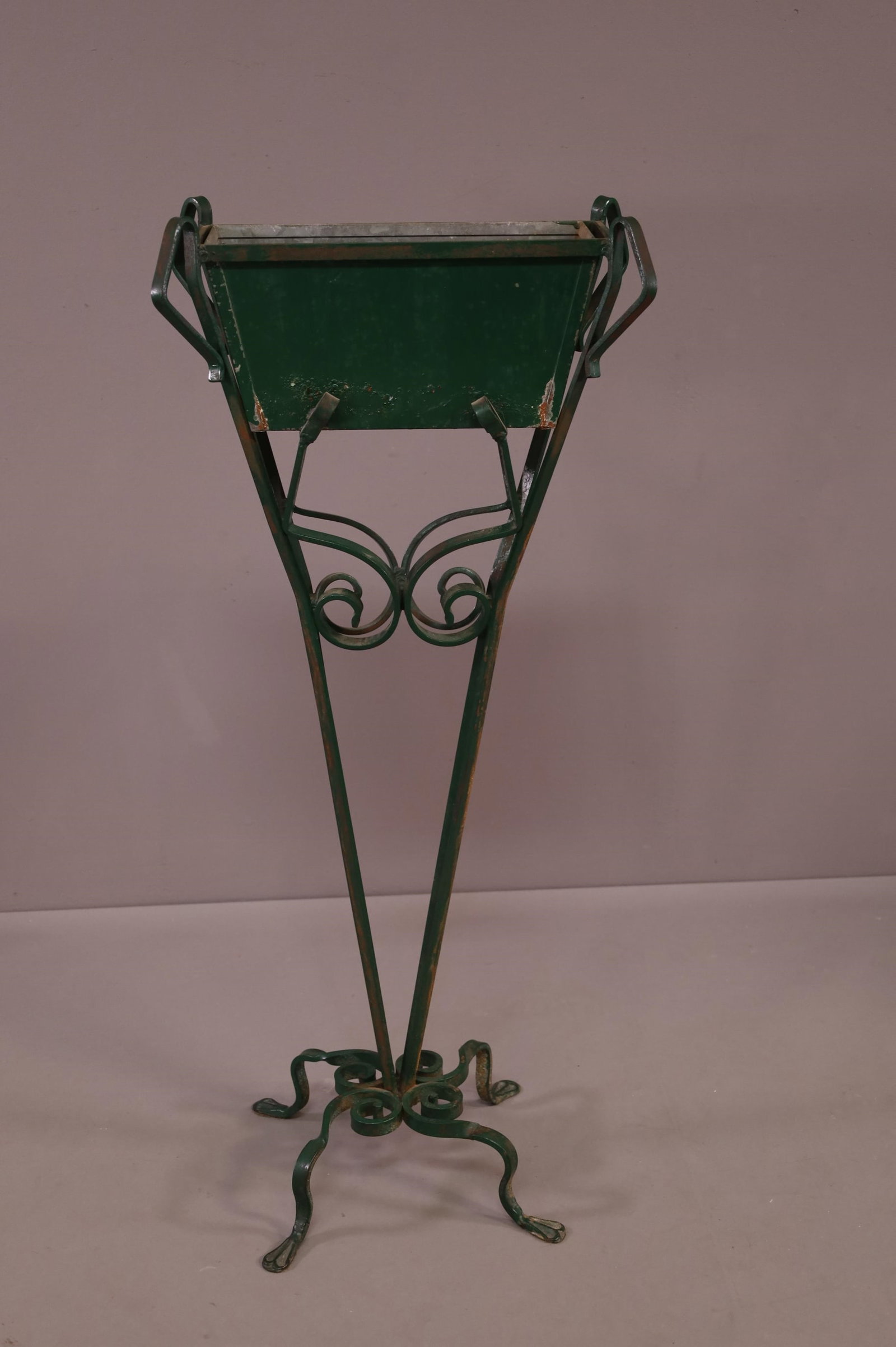 ANTIQUE SPANISH STYLE IRON PLANTER: TALL IRON PLANTER, PAITNED FINISH. WITH LINER. SOME RUST AND PAINT LOSS. 16" x 5" x 43" H. THIS ITEM EXCEEDS SIZE LIMITATIONS FOR IN HOUSE SHIPPING.