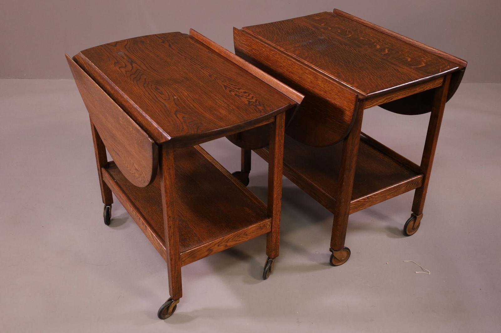 TWO OAK TEA CARTS: TWO OAK DROP SIDE TEA CARTS. ON CASTERS. 27" L x 16" W x 24" H. THIS ITEM EXCEEDS SIZE LIMITATIONS FOR IN HOUSE SHIPPING.