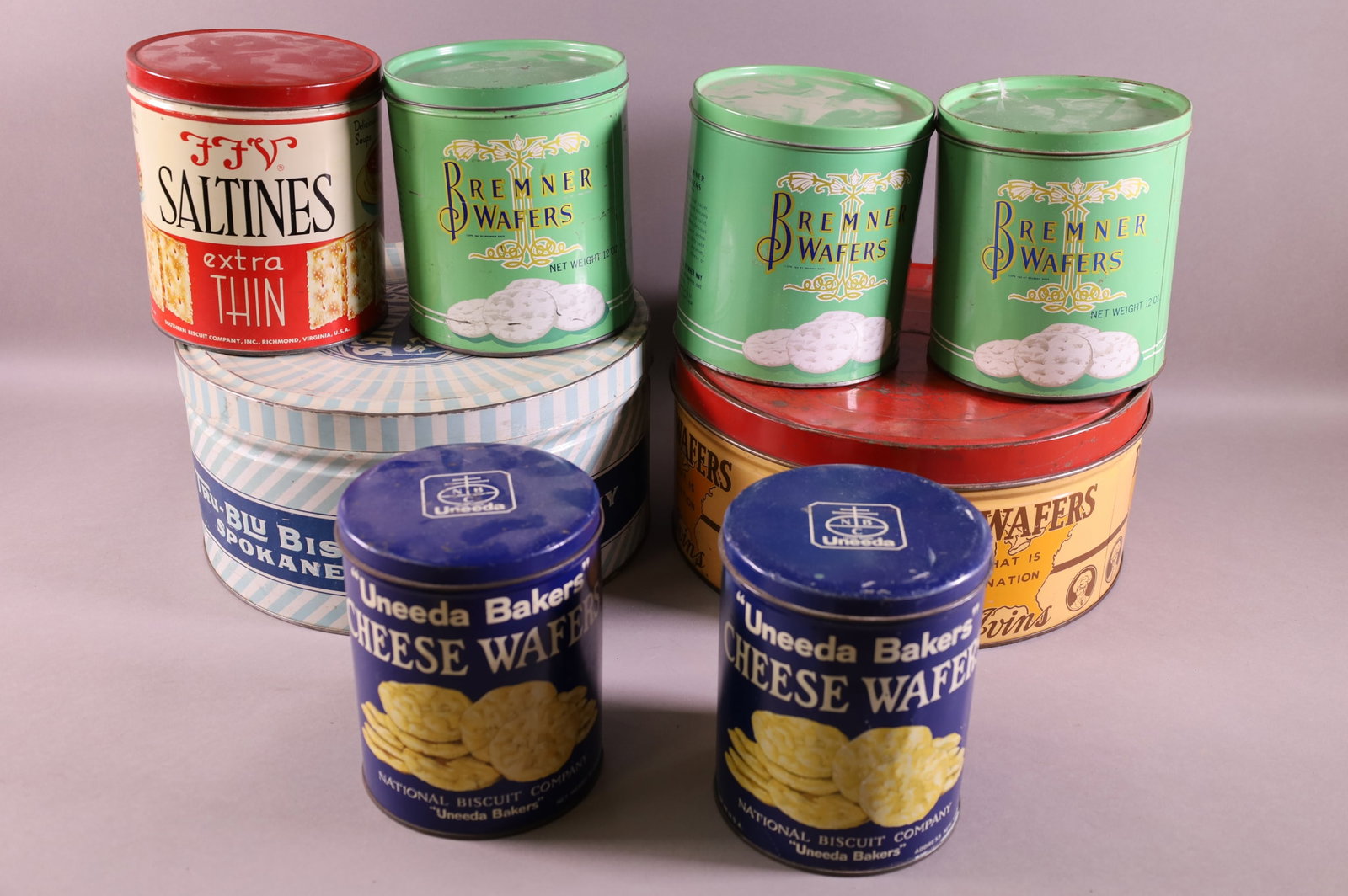 EIGHT CRACKER TINS: BUFFET WAFERS, BREMNER, & UNEEDA. DENTS.