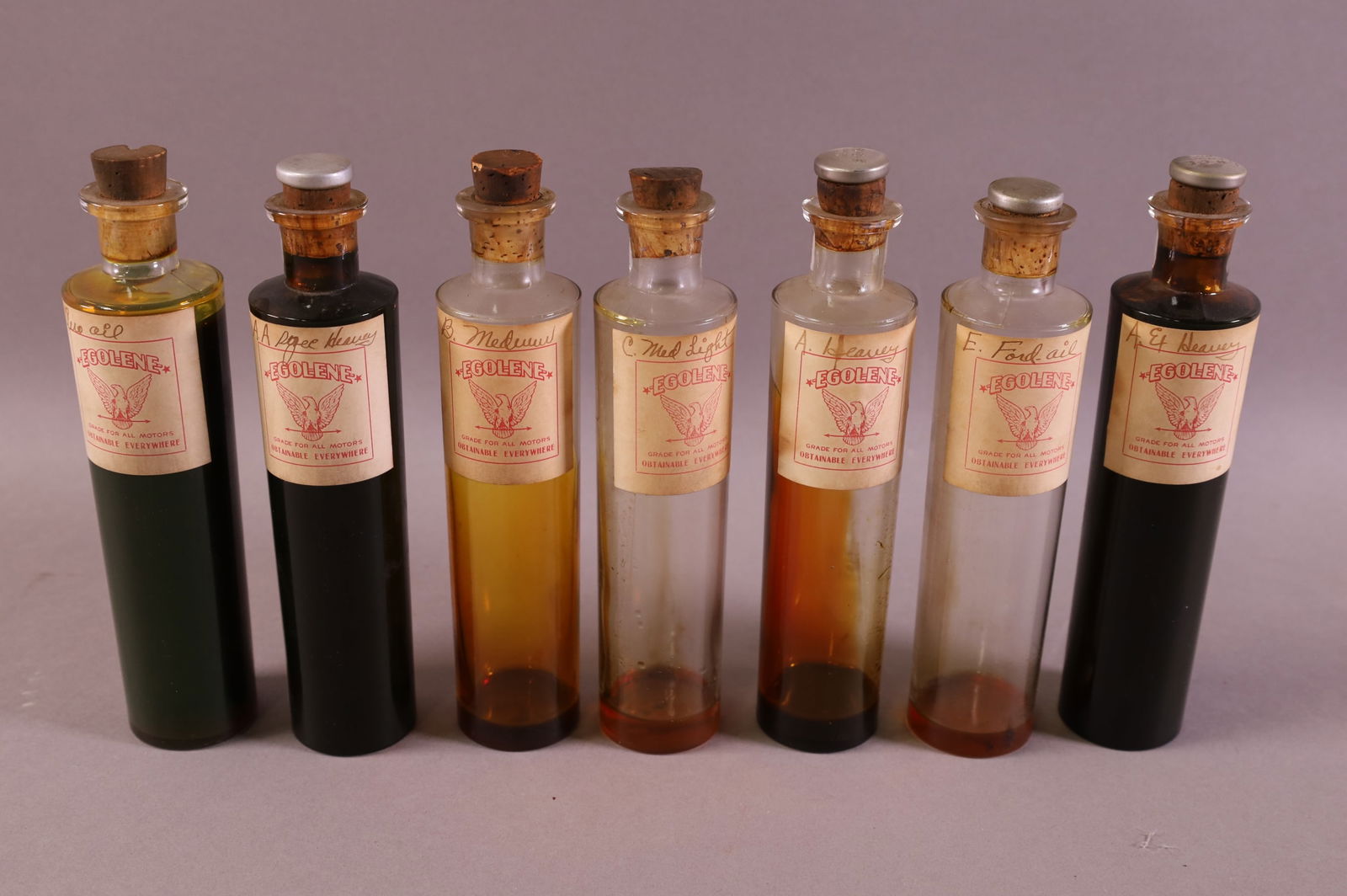 SEVEN EGOLENE SALESMAN SAMPLE OIL BOTTLES (1 of 1)