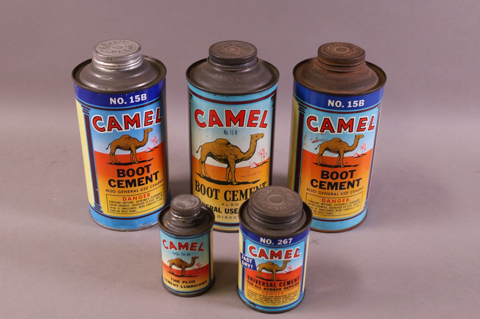 FIVE CAMEL TIRE & BOOT CEMENT CANS: BOOT CEMENT, TIRE PLUG CEMENT.