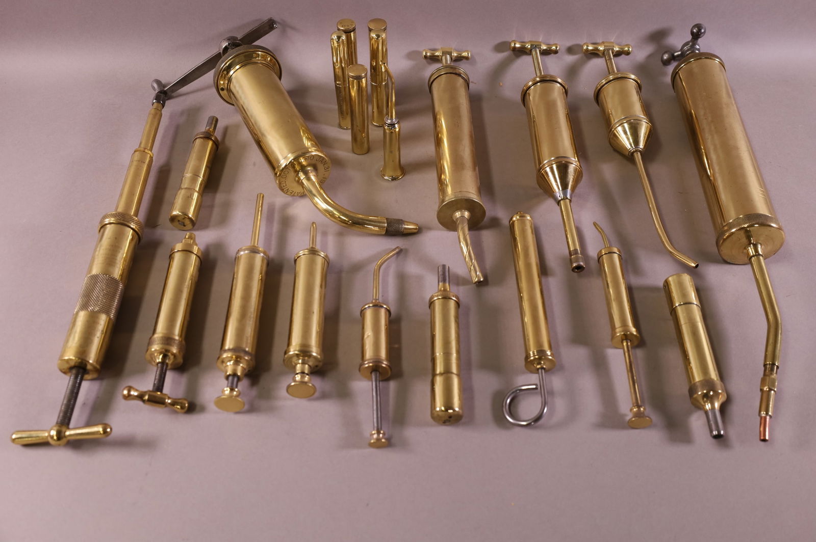 COLLECTION OF BRASS GREASE GUNS (1 of 3)