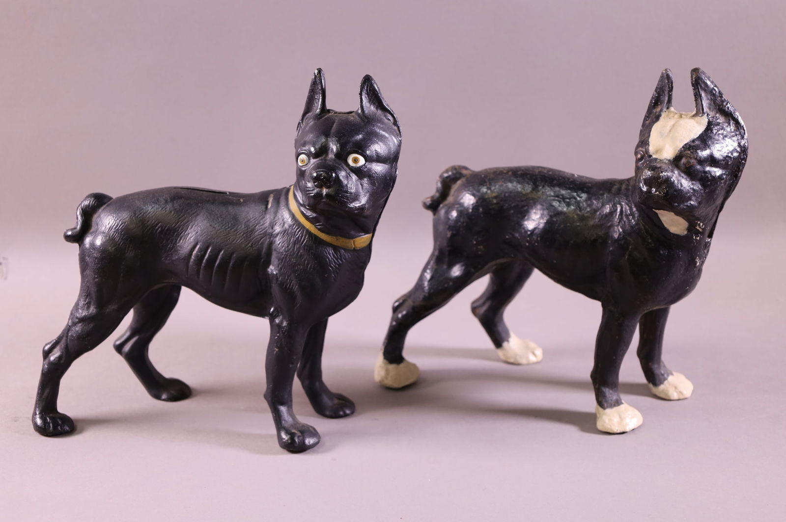 TWO BOSTON TERRIER DOG DOORSTOPS: ONE IS CAST IRON, ONE IS ALUMINIUM. SOME PAINT LOSS. 9 3/4" H