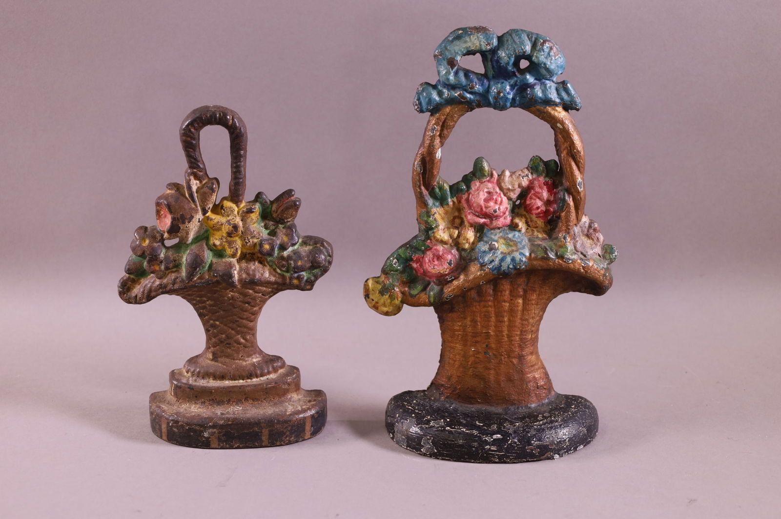 TWO CAST IRON FLOWER BASKET DOORSTOPS (1 of 2)