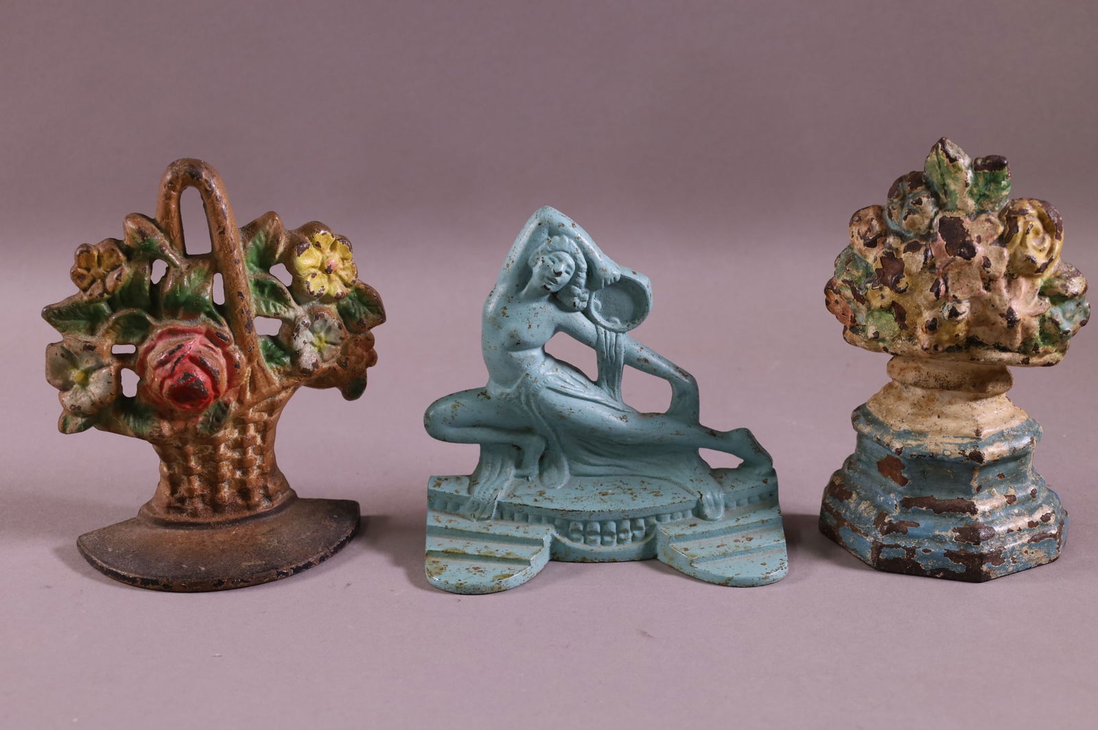 THREE CAST IRON DOORSTOPS (1 of 2)