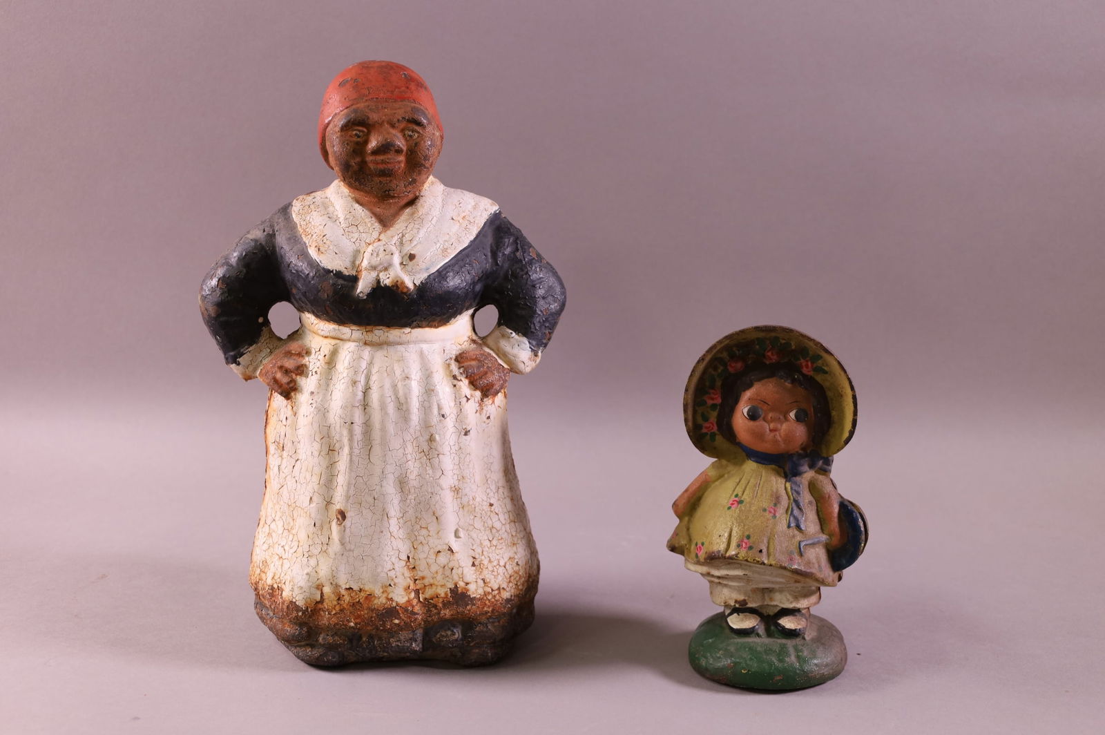 TWO CAST IRON DOORSTOPS (1 of 3)