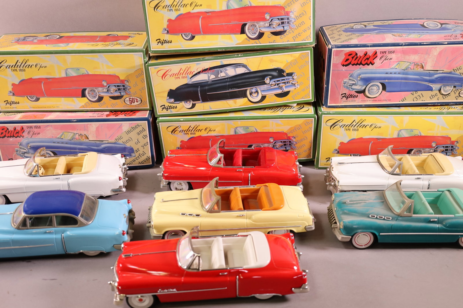 7 FRICTION TOY CARS: IN ORIGINAL BOXES. BUICKS, CADILLACS. PLAYED WITH CONDITION.